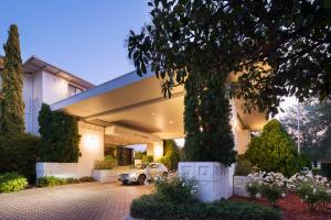 a car parked in front of a building at Ramada by Wyndham Diplomat Canberra in Canberra +38 photos