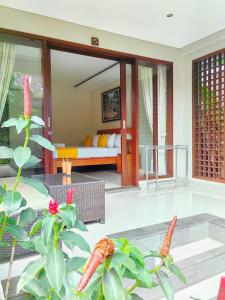 a living room with a couch and a table at ThreeWin Homestay in Ubud