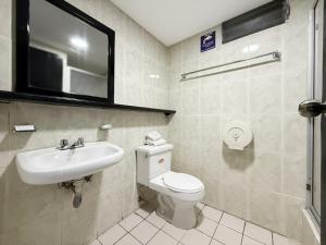 a bathroom with a toilet and a sink at Hotel Santamaria en quito in Quito +58 photos