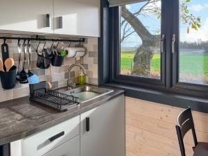 a kitchen with a sink and a window at Barn Owl Cabin - Uk45401 in Forfar