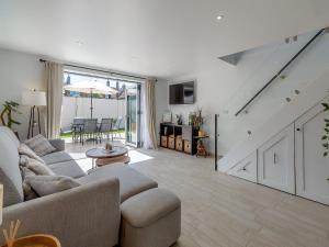 a living room with a couch and a table at Olive Breeze in Felixstowe