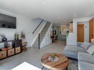 a living room with a couch and a table at Olive Breeze in Felixstowe