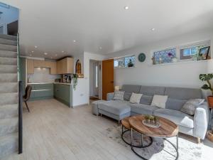 a living room with a couch and a table at Olive Breeze in Felixstowe