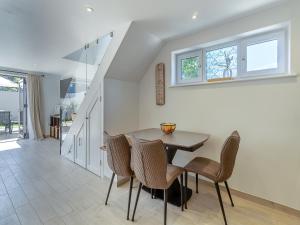 a dining room with a table and chairs at Olive Breeze in Felixstowe
