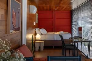 a small room with a bed and a table and a table sidx sidx at Casa Pantuso - Vale do Sol in Nova Lima