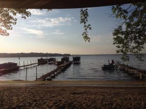 a group of boats in the water near a dock at Lakeland RV Campground Cottage 15 in Edgerton