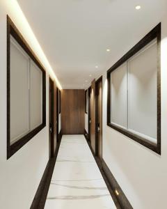a corridor of a hotel with large windows at GREEN WAY HOTEL & RESTAURANt in Gangānagar