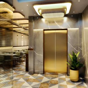 a restaurant lobby with a door and a potted plant at GREEN WAY HOTEL & RESTAURANt in Gangānagar