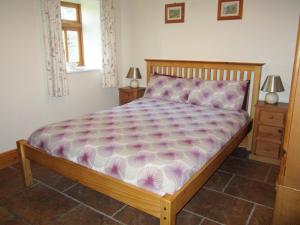 a bedroom with a bed and two night stands at Rievaulx Cottage in Filey