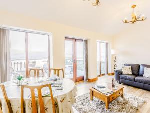 a living room with a table and a couch at Water's Edge - Uk32390 in Dunford Bridge