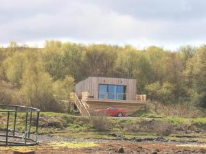a house with a red car parked in front of it at The Duckling in Port na Long +4 photos
