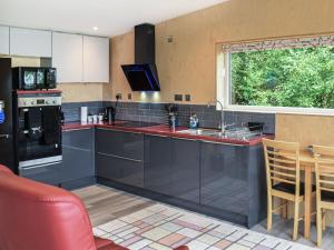 a kitchen with a sink and a counter top at The Duckling in Port na Long