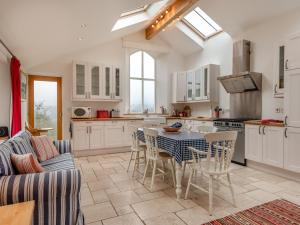 a kitchen with a table and chairs in a room at Hopewell Barn in Hewelsfield +13 photos