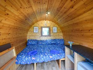 a bed in a room in a log cabin at Beech - Glamping Pod - Uk49945 in Oswestry