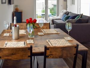 a wooden table with two chairs and wine glasses at The Rest in St. Andrews
