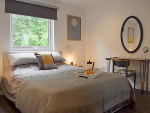 a bedroom with a bed and a large window at The Rest in St. Andrews +7 photos