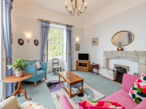 a living room filled with furniture and a fireplace at Cliff House in Beesands