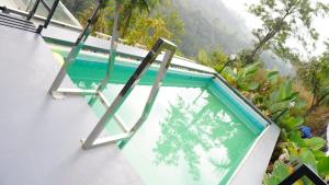 a swimming pool on the side of a house at moonlight palace private pool villa vagamon in Vagamon