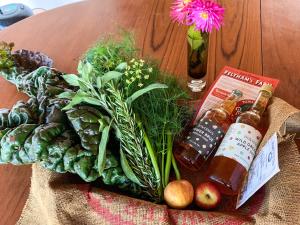 a bunch of vegetables on a table with two bottles at The Organic Cabin - Uk42325 in Horsington