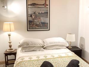 a bedroom with a bed with a picture on the wall at The Organic Cabin - Uk42325 in Horsington
