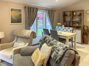 a living room with a couch and a table at Chatsworth Lodge - Uk50983 in Felton