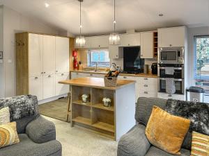 a kitchen with a table and two chairs in a room at Chatsworth Lodge - Uk50983 in Felton