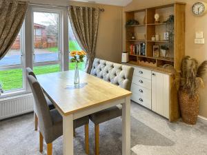 a dining room with a table and chairs at Chatsworth Lodge - Uk50983 in Felton