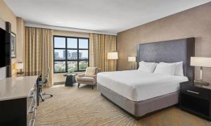 a hotel room with a bed and a chair at Hyatt Regency La Jolla at Aventine in San Diego