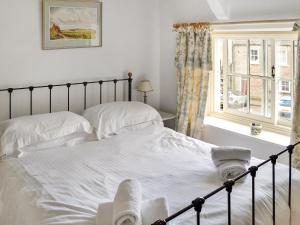 a bedroom with two beds and a window at Newbiggin Cottage in Richmond +8 photos