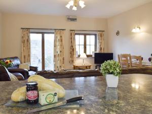 a living room with a table and a couch at Tan-Y-Derwwen in Mydroilin
