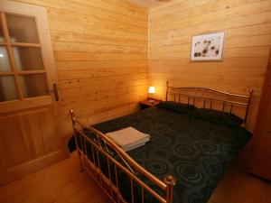 a small room with a bed in a log cabin at Auchenhill Lodge in Lochend
