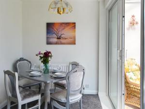 a white dining room with a table and chairs at Dunpullin in Bedlington +12 photos