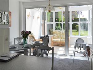 a kitchen and living room with a table and chairs at Dunpullin in Bedlington