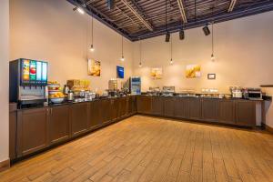 a large room with a food counter in a restaurant at Comfort Inn Montreal - Laval - Highway 15 in Laval
