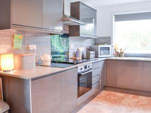 a kitchen with stainless steel appliances and a window at Craignair in Port William