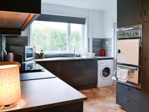a kitchen with a sink and a dishwasher at Craignair in Port William