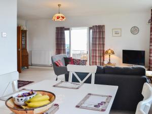 a living room with a table with a bowl of bananas at Craignair in Port William
