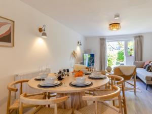 a dining room with a table and chairs and a living room at Pentreath 4 in St Ives