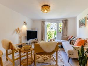a living room with a couch and a tv at Pentreath 4 in St Ives