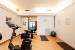 a gym with exercise equipment in a room at Porta Altinia Suites in Treviso