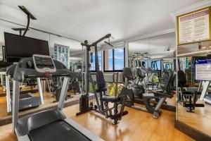 a gym with several treadmills and elliptical machines at Comfort Inn Oceanside Deerfield Beach in Deerfield Beach