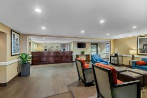 a lobby with a waiting area with chairs and a bar at Comfort Inn & Suites Somerset - New Brunswick in Somerset