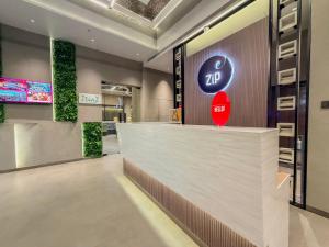 a lobby of a hotel with a reception counter at Zip By Spree Hotels Chinchwad in Chinchwad