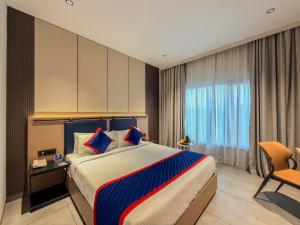 a hotel room with a bed and a window at Zip By Spree Hotels Chinchwad in Chinchwad +36 photos