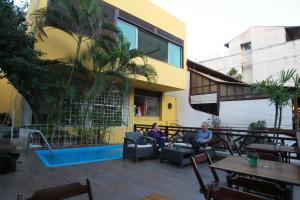 two people sitting on the patio of a building at Hangar Rio Hostel in Rio de Janeiro