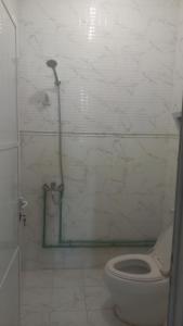 a bathroom with a toilet and a shower at BRAZIL House in Muscat