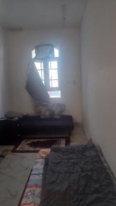 a living room with a couch and a window at BRAZIL House in Muscat +4 photos