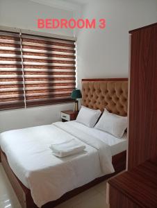 a bedroom with a bed with two towels on it at Trizen Colombo Luxury 3 Bedroom Apartment in Colombo +20 photos