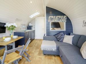 a living room with a couch and a table at Gwennol- Uk37573 in Llanboidy