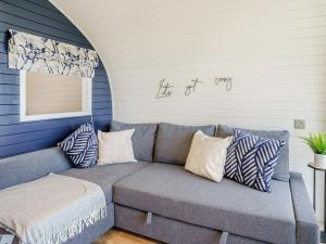 a couch in a living room with blue walls at Gwennol- Uk37573 in Llanboidy +9 photos